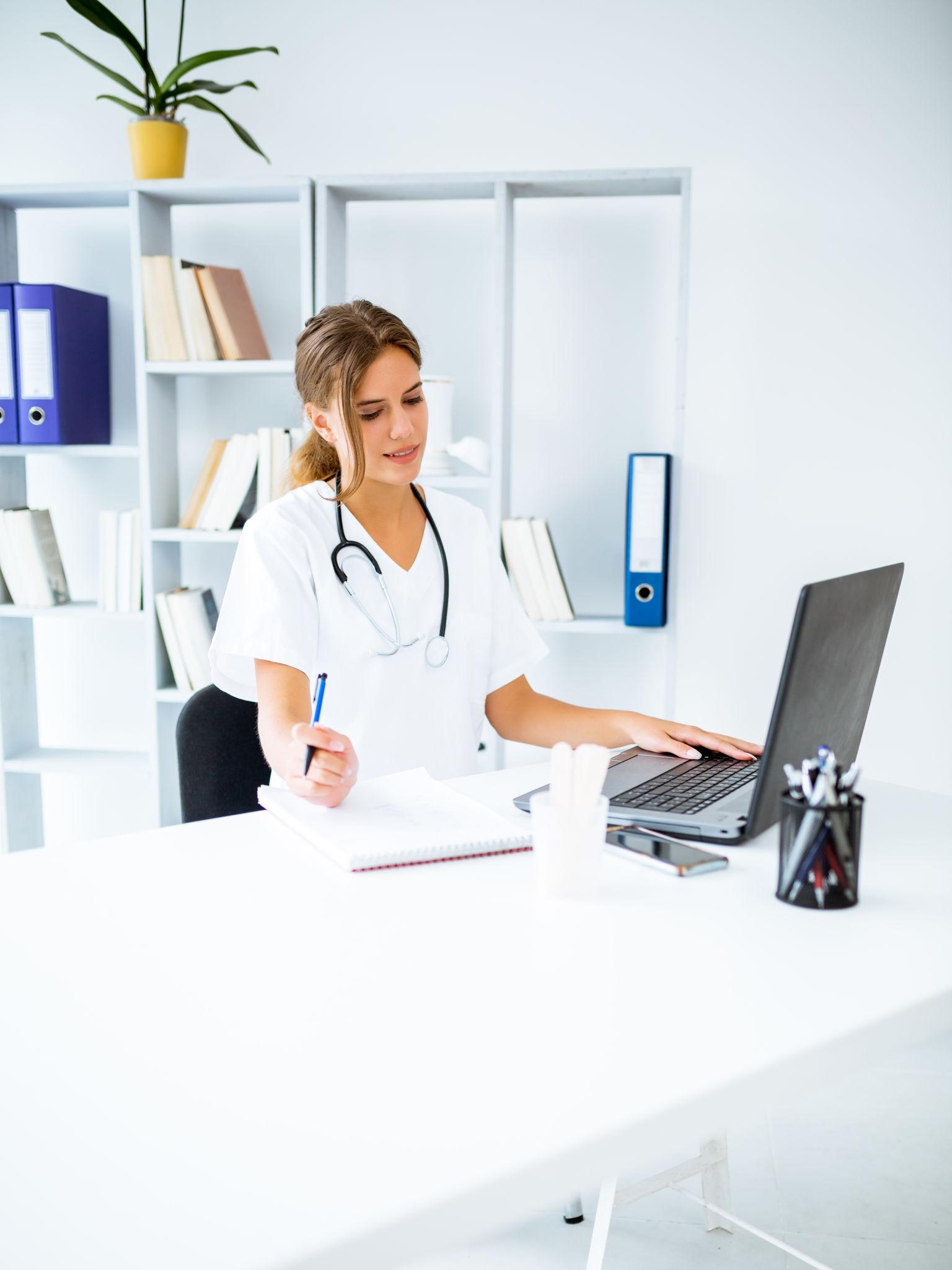 Clinician using MedFlo workflow tools at a clinic desk
